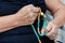 Closeup shot of an elder male's hands holding a brown green rosary