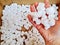 Closeup shot of expanded polystyrene chips in someone\'s hand for shipping