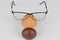 Closeup shot of a face figure made with glasses and a wooden nose on a white background