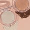 Closeup shot of face powder for makeup, bronzer, blusher, and highlighter