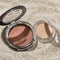 Closeup shot of face powder for makeup, bronzer, blusher, and highlighter