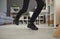 Closeup shot of feet of a man who trips over an electric cord at home or in the office