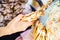 Closeup shot of a female hand holding a bunch of traditional bobbin lacemaking tools