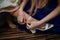 Closeup shot of female hands attaching the bride shoe buckle