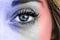 Closeup shot of a female\'s eye with the colors of the French flag