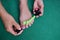 Closeup shot of a female with a toe separator painting her toenails with pink polish