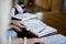 Closeup shot of females reading the bible and taking notes with a blurred background