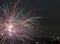 A closeup shot of festive fireworks spreading happiness in the night sky