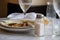 Closeup shot of finished dinner set up with plates and glasses on table in a restaurant