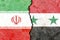 Closeup shot of the flags of Iran and Syria on a cracked wall