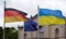 Closeup shot of  flags of Ukraine, Germany, and the EU waving in the wind