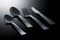 Closeup shot of flatware on a black surface