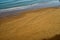 Closeup shot of footsteps on the beach on a sunny day