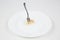 Closeup shot of a fork stuck in a piece of fish in a white plate isolated on a white background