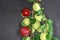 Closeup shot of fresh Mirabelle plums on a branch on a black surface