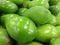 Closeup shot of fresh unripe green mangos at a fruit market