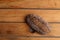 Closeup shot of freshly-baked homemade artisanal brown bread with nuts on a wooden surface