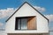 Closeup shot of a gable roof with a single window and black triangular frame