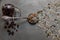 Closeup shot of a glass pitcher full of raisins and a spoon with walnut, sunflower, and pumpkin