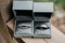 Closeup shot of gray boxes with bride and groom engagement rings