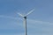 Closeup shot of a gray wind turbine with clear skies