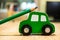 Closeup shot of green sharpened pencil on a green car toy