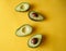 Closeup shot of a group of avocados on a yellow background