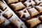 Closeup shot of a group of homemade fresh puff pastries with sprinkled sugar powder