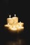 Closeup shot of a group of seven burning candles with black background