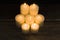 Closeup shot of a group of seven burning candles with black background