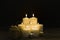 Closeup shot of a group of seven burning candles with black background