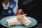 Closeup shot of a half sliced burrito on a blue plate