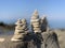 Closeup shot of hand-building stone in beach stack of stones