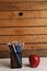 Closeup shot of a handful of colorful pencils and a red apple - perfect for background