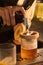 Closeup shot of the hands of a bartender making a smoked wine with blur background