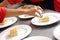 Closeup shot of hands of cooks preparing biscuits with vanilla ice cream in a restaurant