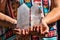 Closeup shot of hands holding clear beautiful crystal tower minerals