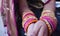 Closeup shot of hands of Indian female wearing colorful bangles