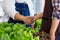 Closeup shot handshaking together of unrecognizable unknown two male farmers in apron when agriculture business agreement