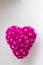 Closeup shot of a hanging pink rose bouquet heart pinata with white background