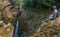 Closeup shot of a Hispanic hiker sitting on top of the Popocatl waterfall