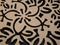 Closeup shot of hollow floral patterns carved on a wood piece can be used as background