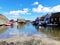 Closeup shot of houses and multicolored boats in the water in Gjeving, Norway