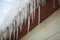 Closeup shot of the icicles hanging from the rooftop of a house on the blurred background