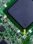 Closeup shot of the integrated electric circuits of a green chip