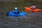 Closeup shot of kayakers in blue and orange boats on the Youghiogheny River near Friendsville