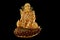 Closeup shot of Lakshmi statue made of pure gold on the black background