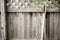 Closeup shot of leaf rake and shovel handle leaned again a wooden fence in the backyard