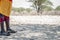 A closeup shot of legs and clothes of a samburian warrior in the desert in kenya/africa.