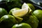 Closeup shot of lime slices on a heap of freshly washed limes in bright light with blur background